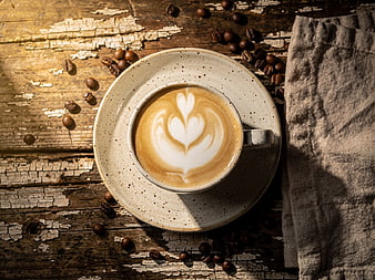 Top View of Artisan Latte with Latte Art on Rustic Wood
