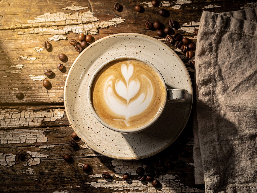 Top View of Artisan Latte with Latte Art on Rustic Wood