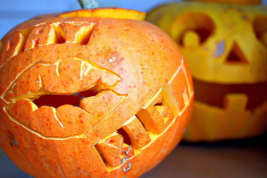 Close-up of carved Halloween pumpkin with jagged mouth