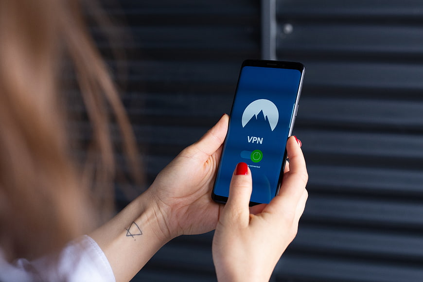 Woman using VPN app on smartphone for internet security