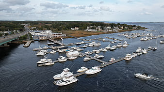 Aerial View of Busy Harbor with Docked Boats and Coastal Town
