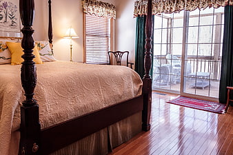 Cozy Bedroom Interior With Four Poster Bed And Sliding Glass Door