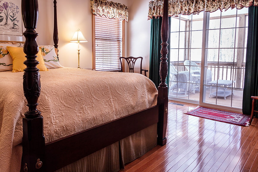 Cozy Bedroom Interior With Four Poster Bed And Sliding Glass Door
