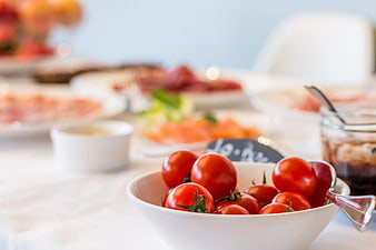 Fresh Cherry Tomatoes in White Bowl on Buffet Table
