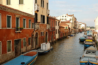Venetian canal with colorful buildings and moored boats