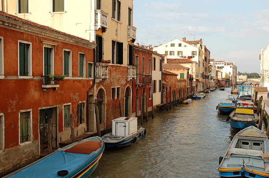 Venetian canal with colorful buildings and moored boats