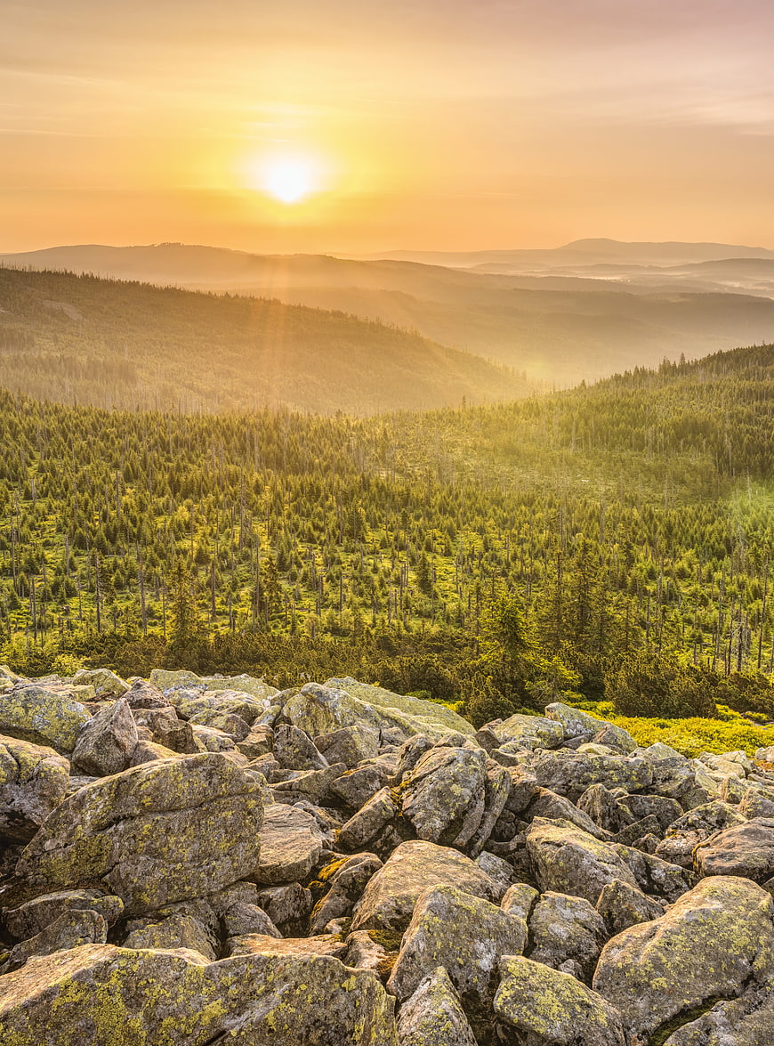 Sunrise Over Bavarian Forest Mountains With Rocky Foreground