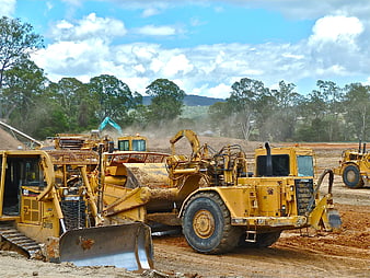 Heavy Yellow Construction Machinery Parked On Earthwork Site
