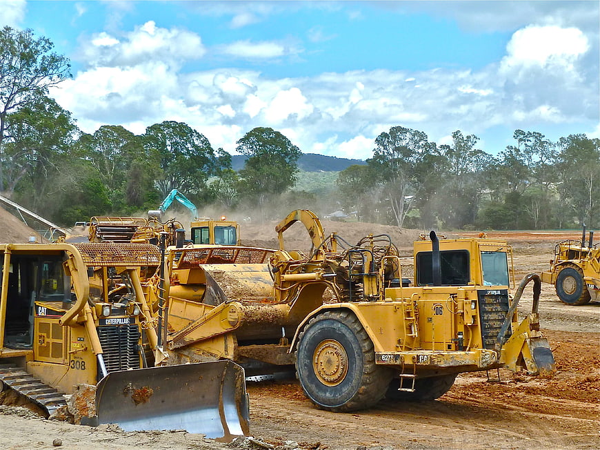 Heavy Yellow Construction Machinery Parked On Earthwork Site