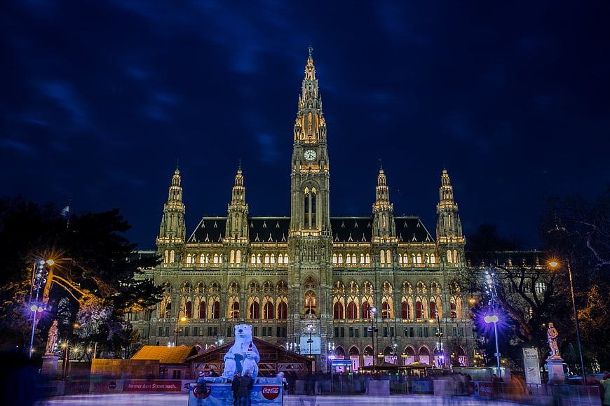 Vienna City Hall Illuminated At Night With Christmas Market And Ice Rink