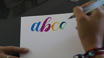 Hand painting colorful calligraphy letters abc on white paper