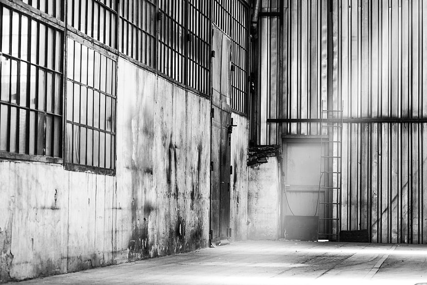 Black and white abandoned industrial factory interior