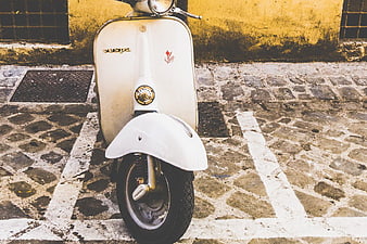 Vintage White Vespa Scooter on Cobblestone Street