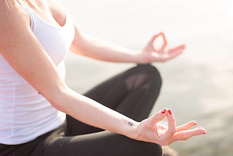 Woman meditating in lotus pose with hands in mudra