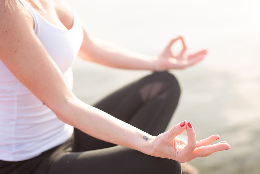 Woman meditating in lotus pose with hands in mudra