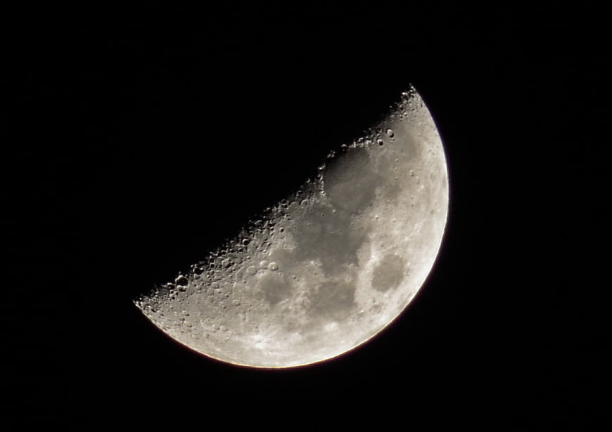 Crescent Moon with Craters Against Black Night Sky