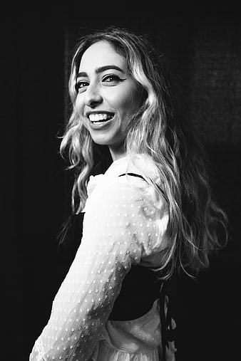 Black and white portrait of smiling woman with wavy hair