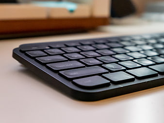 Close-up of black computer keyboard on wooden desk