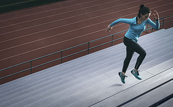 Woman Jumping on Stadium Stairs During Workout