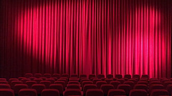 Empty Movie Theater With Red Velvet Curtains And Rows Of Seats