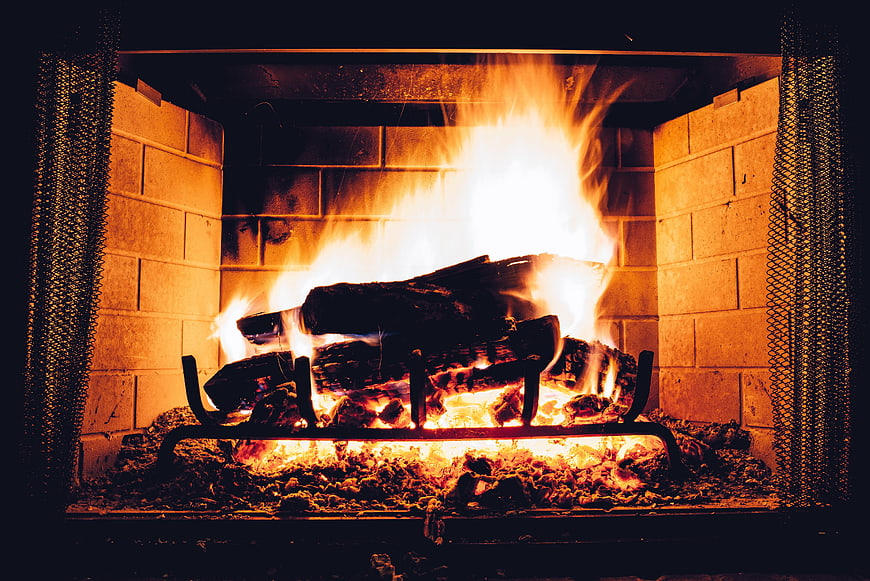 Cozy Fire Burning in Brick Fireplace with Logs