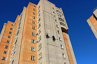 Window Cleaners Hanging on High-Rise Building Facade
