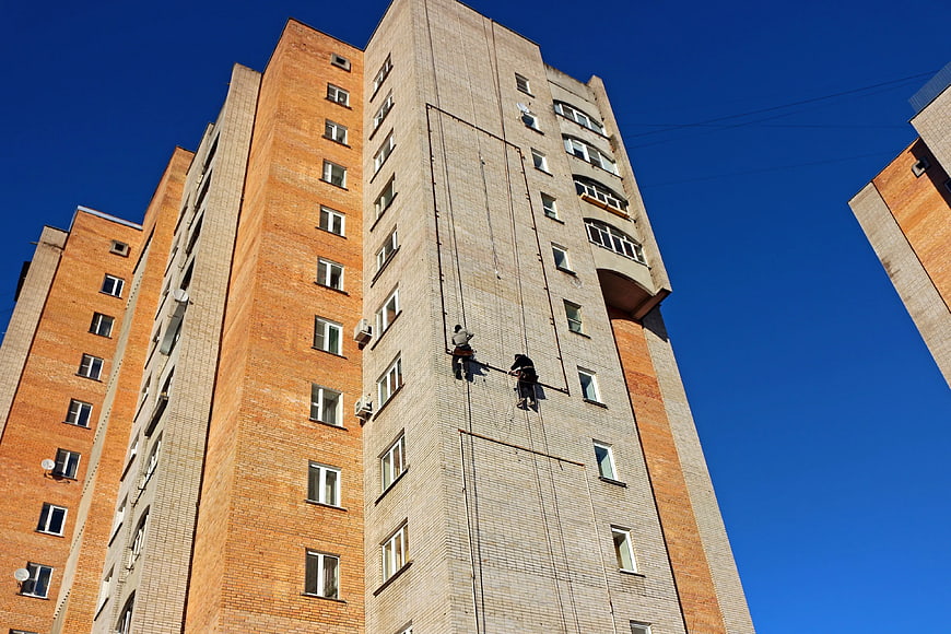 Window Cleaners Hanging on High-Rise Building Facade