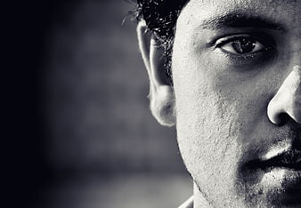 Black and white close-up of a man's eye and profile