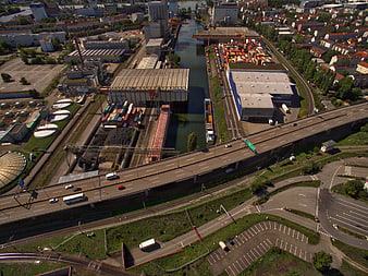 Aerial view of industrial port, highway, and canal infrastructure