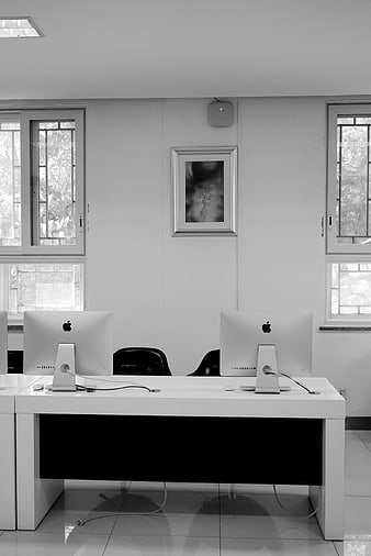 Minimalist Black and White Office Workspace with Computers