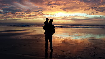 Silhouette of Father and Child Watching Beach Sunset