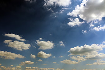 Dramatic Blue Sky with White Clouds and Sun Rays