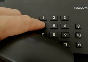 Hand Pressing Button On Black Telecom Telephone Keypad