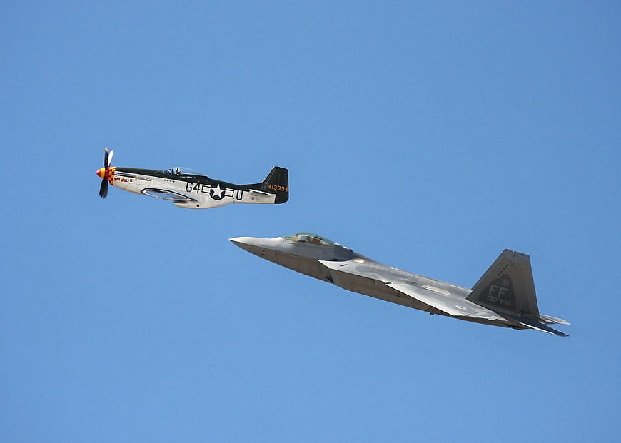 Vintage P-51 Mustang and Modern F-22 Raptor Flying Together