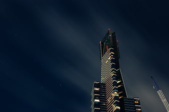 Modern Skyscraper at Night with Starry Sky