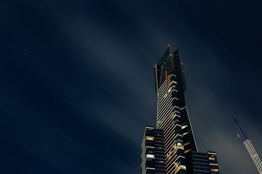 Modern Skyscraper at Night with Starry Sky