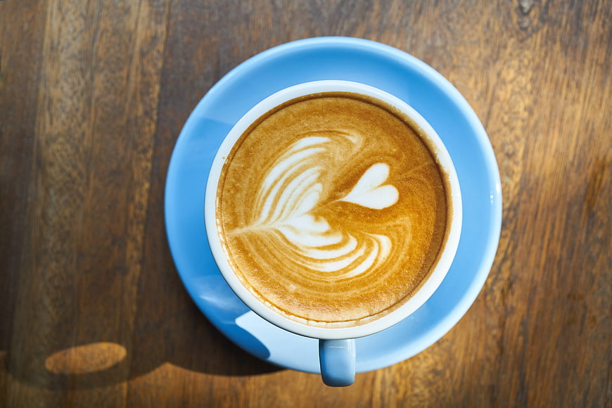 Top View of Blue Coffee Cup with Heart Latte Art