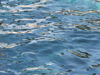 Abstract Blue Water Surface with Ripples and Reflections