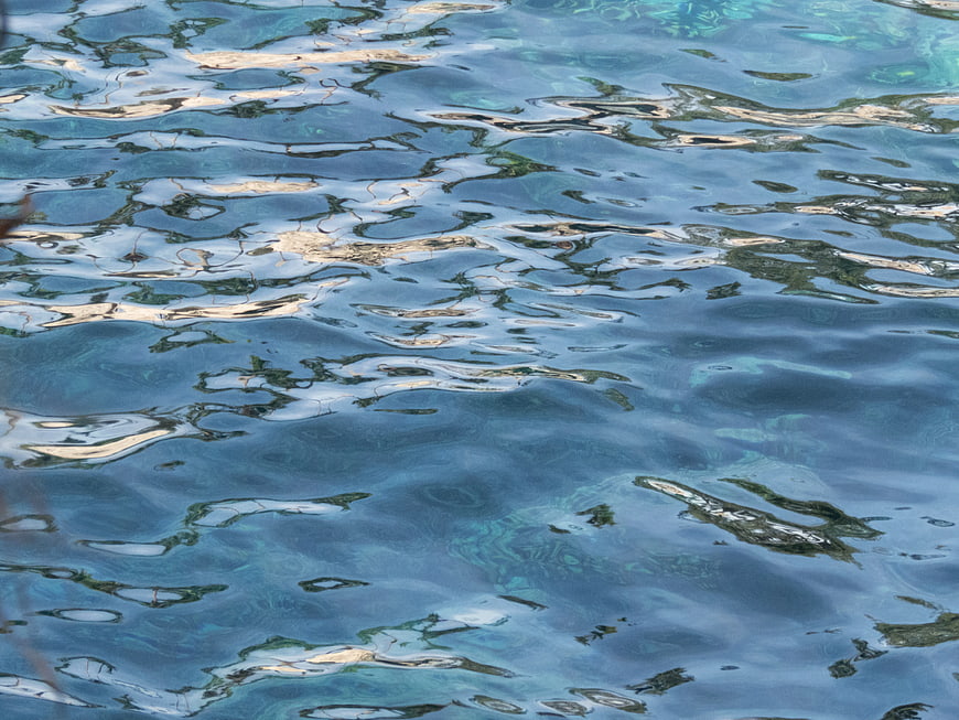 Abstract Blue Water Surface with Ripples and Reflections