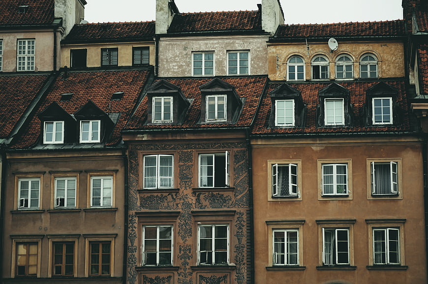 Colorful historic European townhouses with red tiled roofs