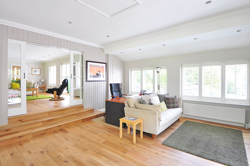 Bright modern living room with white sofa and wooden floors