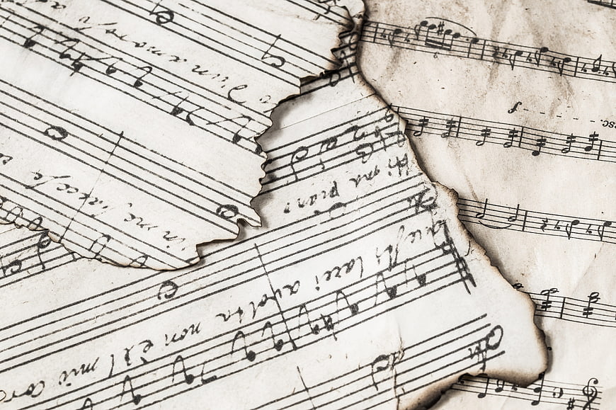 Vintage Burnt Sheet Music with Torn Edges