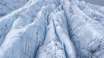 Close-up texture of blue glacier ice crevasses