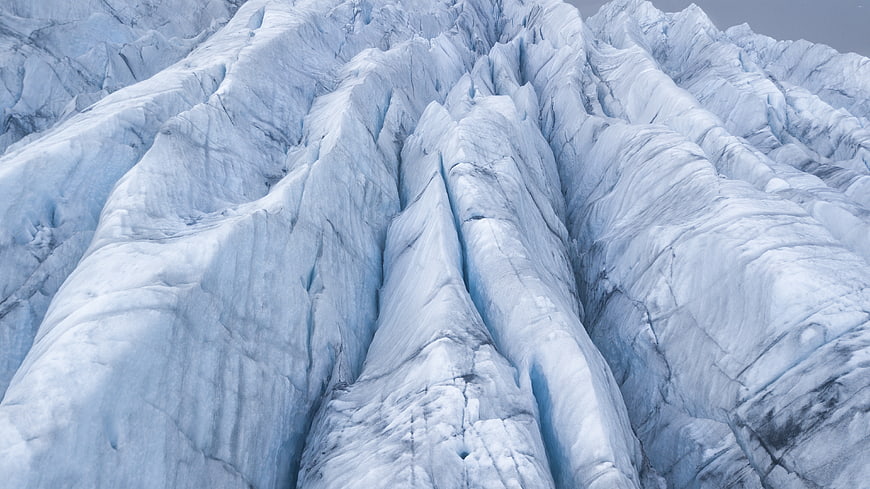 Close-up texture of blue glacier ice crevasses
