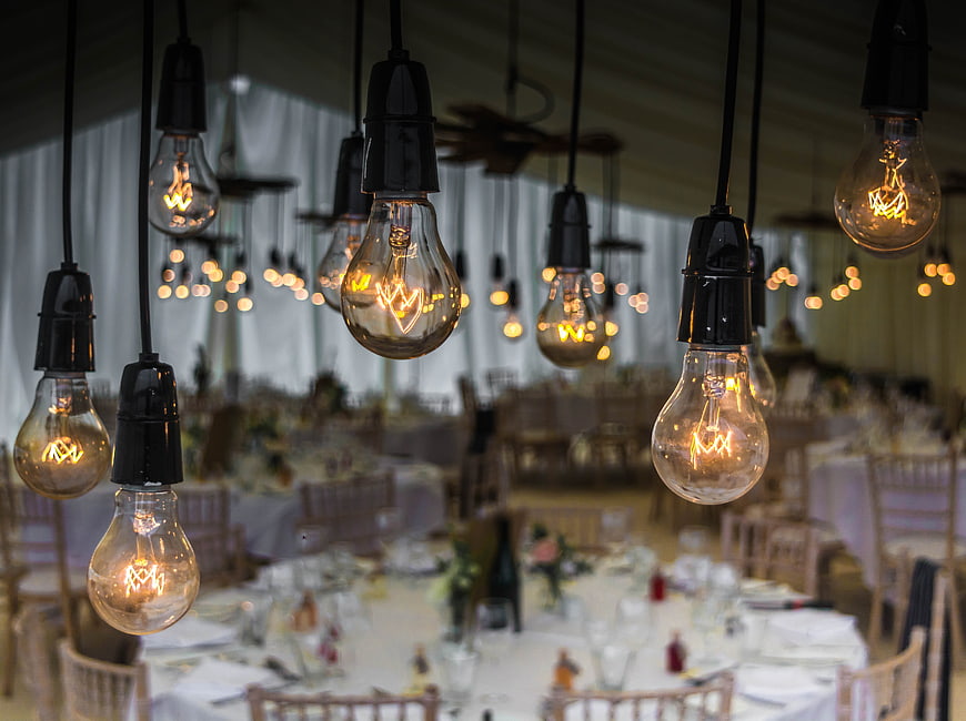Vintage Edison Bulbs Hanging Over Wedding Reception Tables