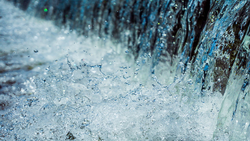Close-up of splashing water drops and flowing stream
