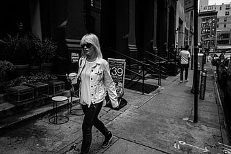 Woman Walking on City Street in Black and White