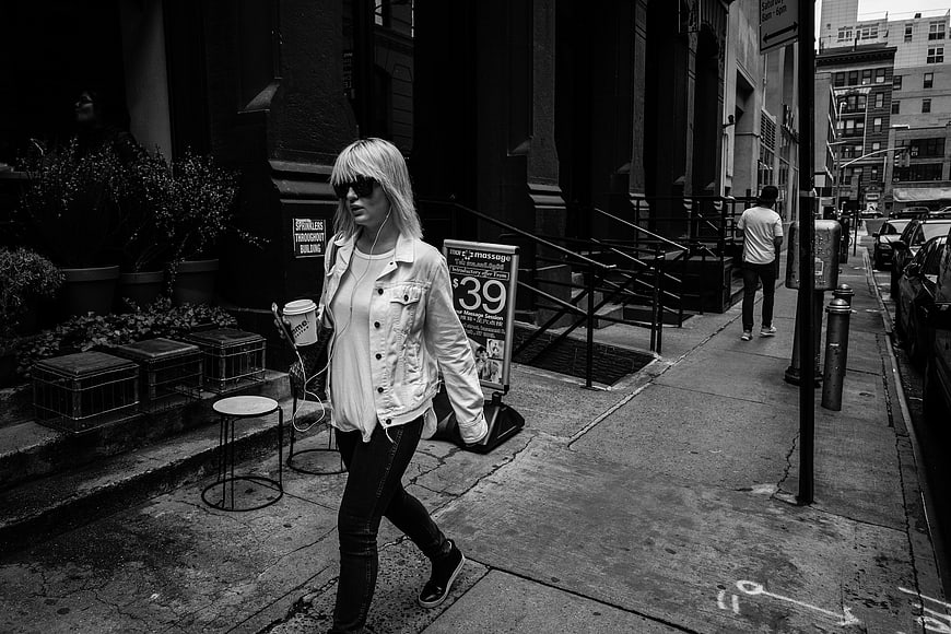 Woman Walking on City Street in Black and White