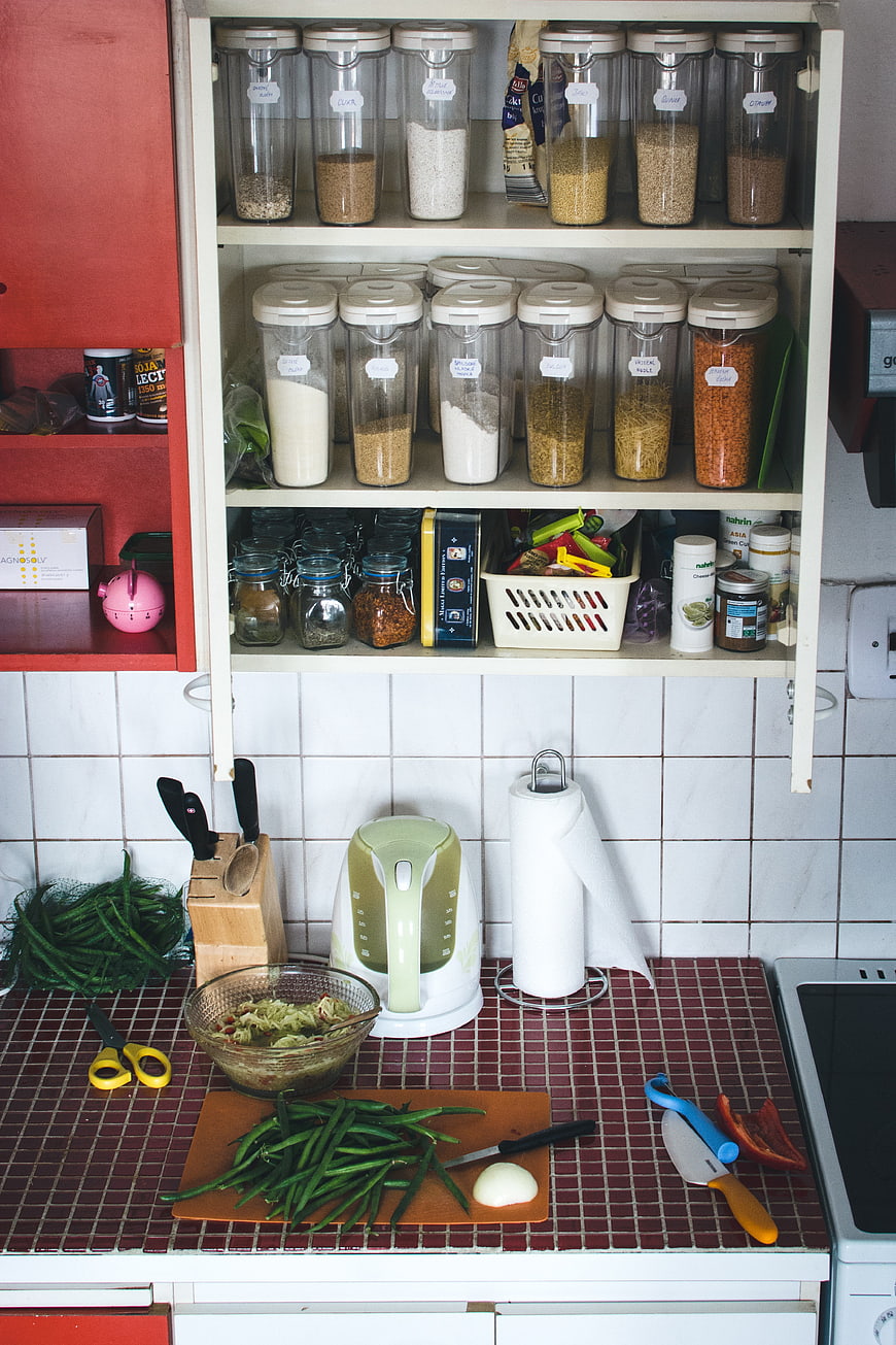 Vintage kitchen counter with fresh vegetables and organized pantry