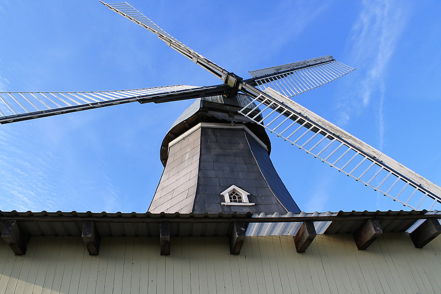Low angle view of traditional windmill against blue sky